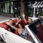 White 1965 Mustang convertible interior with passengers